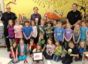 Mr. Mackie's grade three class from Kootenay Orchard elementary celebrating Hope Ewaskow's honourable mention in the Burn Awareness week poster contest. The class is also excited about their upcoming pizza party.