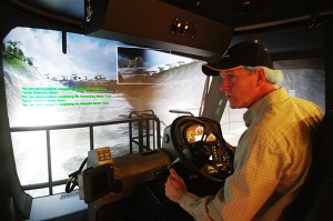 Program graduate Darcy Wiebe shows his newly-honed skills on the haul-truck simulator for the visiting dignitaries Wednesday morning.