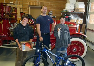 Pictured from left to right is: Linden Elliott, Fire Fighter Jeremy Bertrand and Keenan Harris.