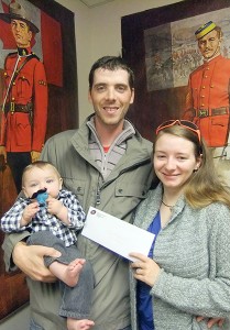 Parents, Ryan & Mary McFarlane pose with son Lucas after receiving the winning prize of $50 for the 2014 Sam Steele Days Photo Contest.