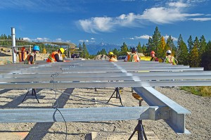 Crews work to assemble tabletop supports on which photovoltaic modules are mounted. Photo by John Allen