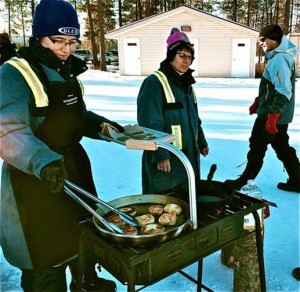 Sharron and Sherrie cook up fresh hot bannock. Photo by Maralyn Bowen Click to enlarge images