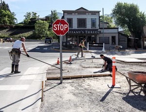Max Helmer Construction workers install the footpath along 7th Avenue. Photos by Chris Conway
