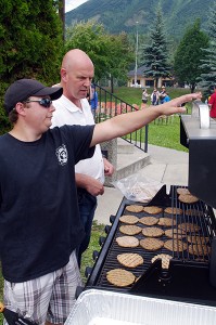 More good news is coming, said MP Wilks Friday afternoon, in terms of federal funding coming  into the riding the next while. Here he takes a station at the barbecue following the funding announcement.