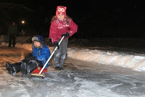 Megan sweeps her brother Justin down the ice at last year's New Year's Eve party.