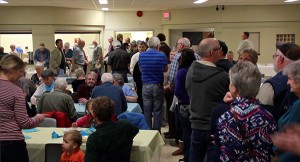 Some of almost 300 at Wasa Community Hall, enjoying Spaghetti, salad and dessert while busy volunteer cooks from both the Wasa Lions and KRRG (background) efficiently work together to meet the demand.