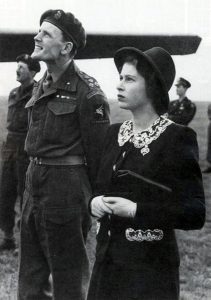 Elizabeth watches fly-past. She looks very young in this photograph. 