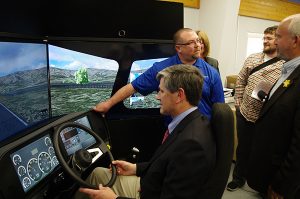 Advanced Education Minister Andrew Wilkinson takes a spin on the semi-truck driving simulator at COTR's Gold Creek Campus.