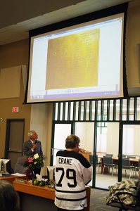 RDEK board chair Rob Gay unveils a plaque that will commemorate Lee-Ann Crane's service to the region.