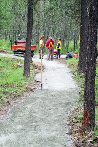 Trail workers politely wait for the funding celebration entourage and media to move on.