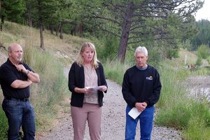 RDEK Electoral Area F Director and UBCM board member Wendy Booth addresses sod turning guests this afternoon, while RDEK board chair Rob Gay, right, and City of Cranbrook Coun. Ron Popoff listen.