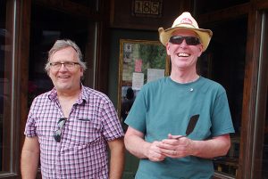 Mayor Don McCormick, right, with Kimberley and District Chamber of Commerce executive director Mike Gaurnery serving cake in the Platzl on Canada Day. Carrie Schafer/e-KNOW photo