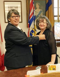 Mayor Mary Giuliano is presented the first poppy Oct. 26 by the Fernie Royal Canadian Legion, marking the launch of the annual poppy fund collections.