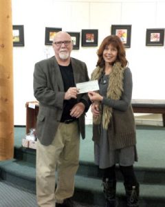 Bill Roberts of West Kootenay Brain Injury Association receives a $4,000 grant from Director Michelle Lemay.